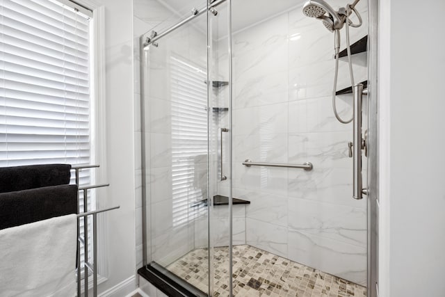 bathroom with a shower with door