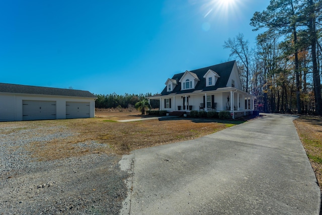 view of front of property with a garage, a front yard, and a porch