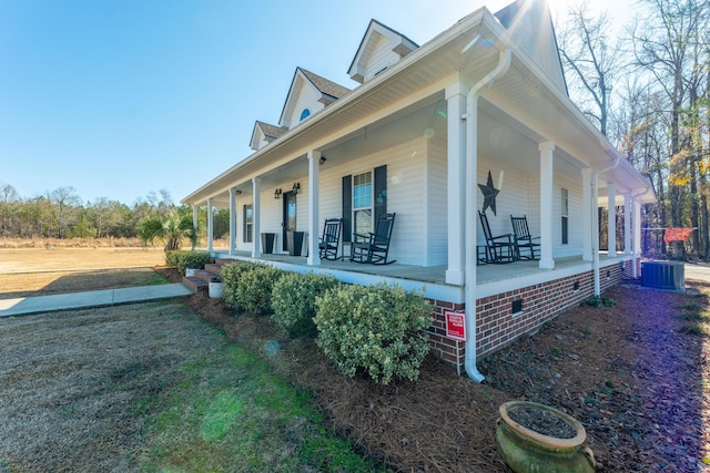 view of side of property featuring central AC and covered porch