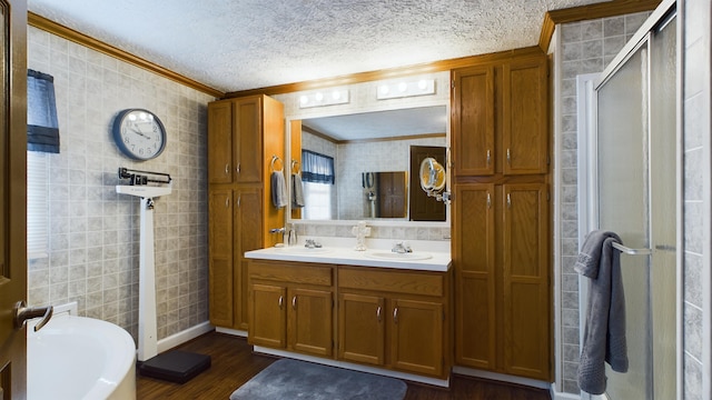 bathroom with independent shower and bath, ornamental molding, wood-type flooring, and a textured ceiling