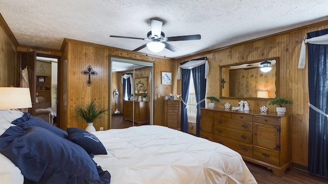 bedroom featuring dark wood-type flooring, ornamental molding, and a textured ceiling