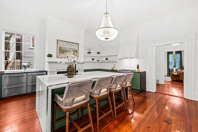 dining room with ornamental molding, a notable chandelier, and dark hardwood / wood-style flooring