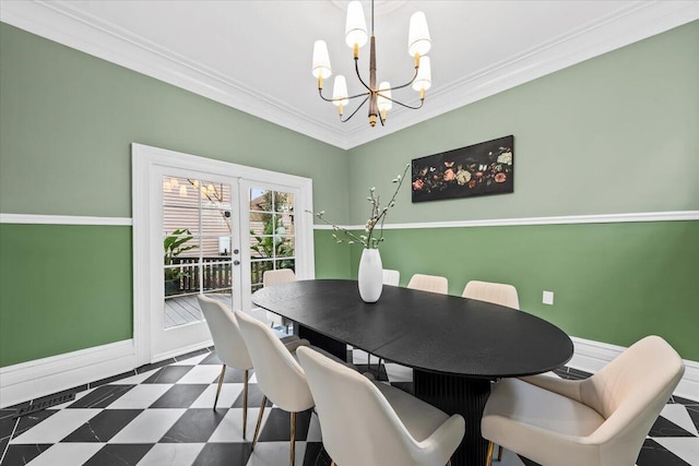 dining space with crown molding, french doors, and a chandelier