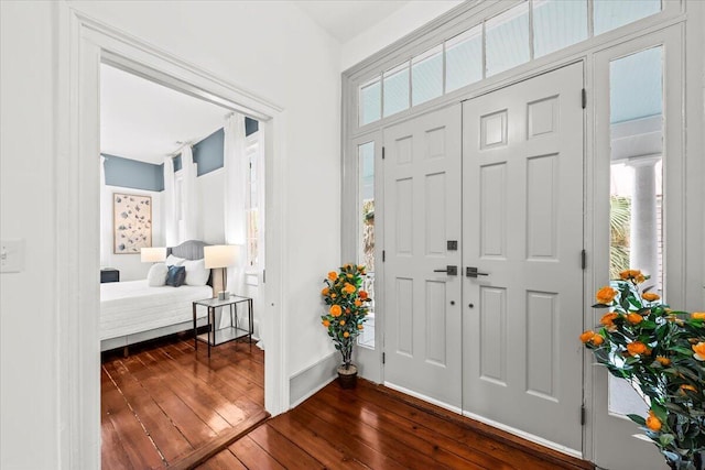 entryway with dark hardwood / wood-style flooring