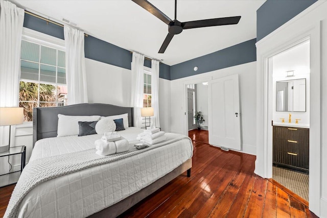 bedroom with hardwood / wood-style floors, ceiling fan, and ensuite bathroom