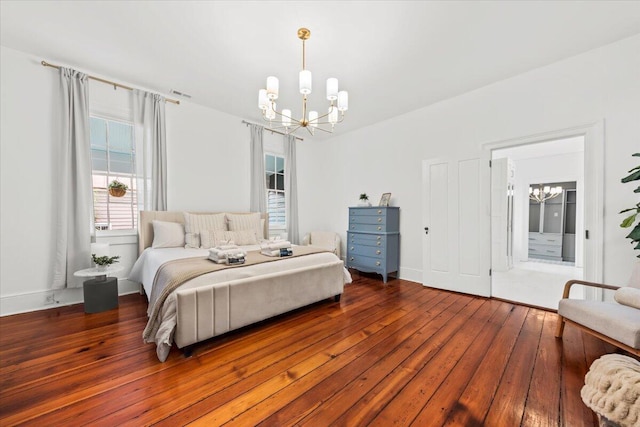 bedroom with an inviting chandelier and hardwood / wood-style flooring