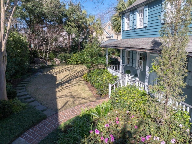 view of yard featuring covered porch