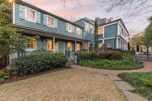 view of front of property with a yard and covered porch