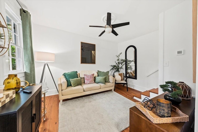 living room featuring hardwood / wood-style flooring and ceiling fan