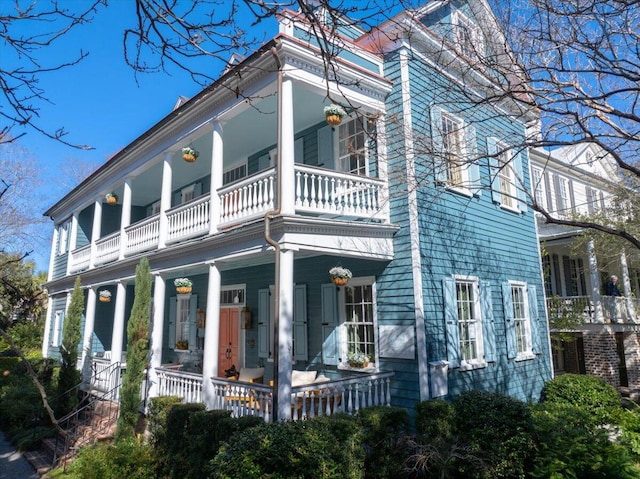 view of home's exterior with a balcony and covered porch