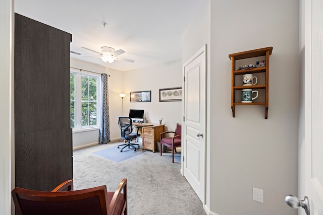 office space with light colored carpet and ceiling fan