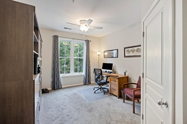 carpeted office featuring ceiling fan