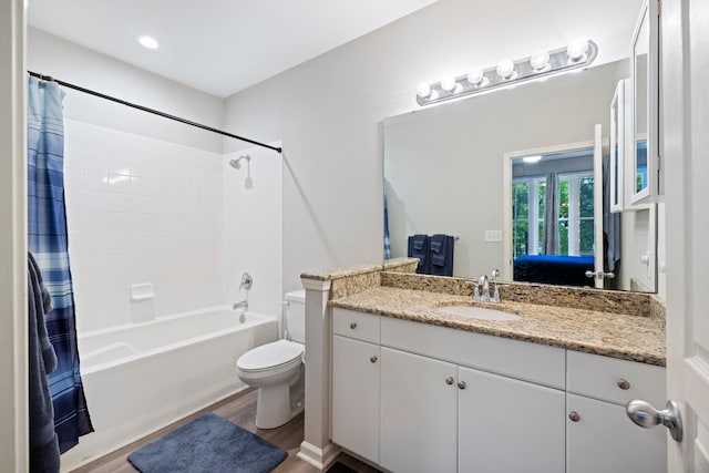 full bathroom featuring shower / tub combo with curtain, vanity, toilet, and hardwood / wood-style floors