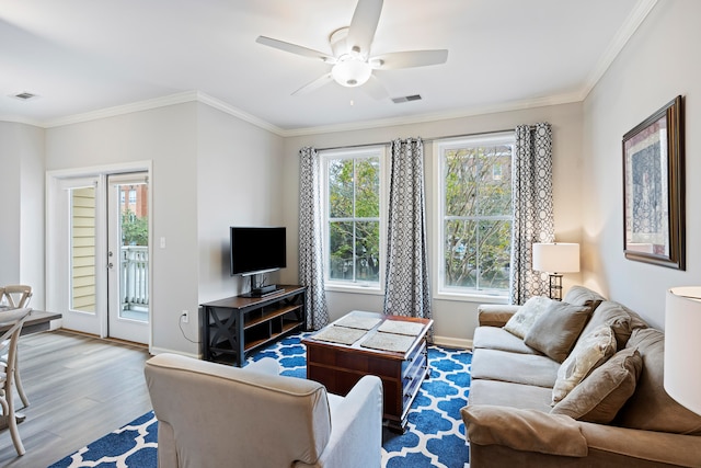 living room with crown molding, ceiling fan, and hardwood / wood-style flooring