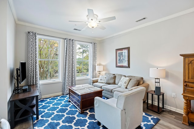 living room featuring wood-type flooring, ornamental molding, and ceiling fan