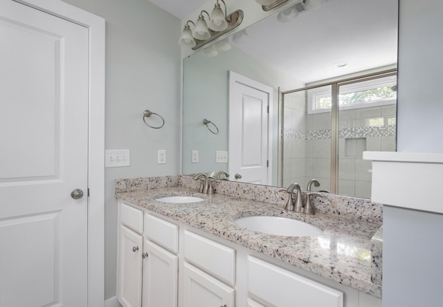 bathroom featuring vanity and an enclosed shower