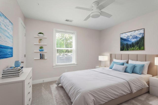 bedroom featuring light colored carpet and ceiling fan