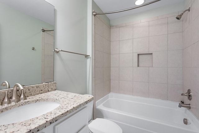 full bathroom featuring vanity, toilet, and tiled shower / bath combo