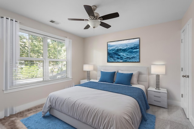 bedroom with light carpet and ceiling fan