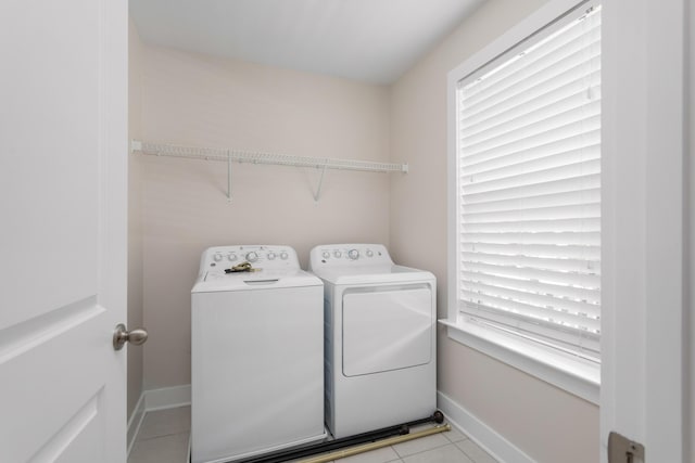 laundry area featuring light tile patterned flooring and separate washer and dryer