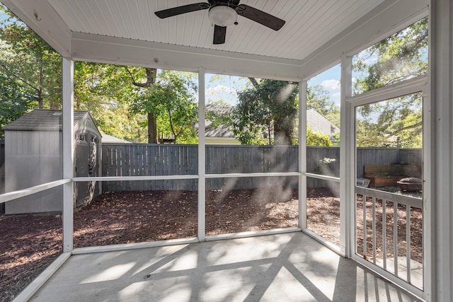 unfurnished sunroom featuring ceiling fan