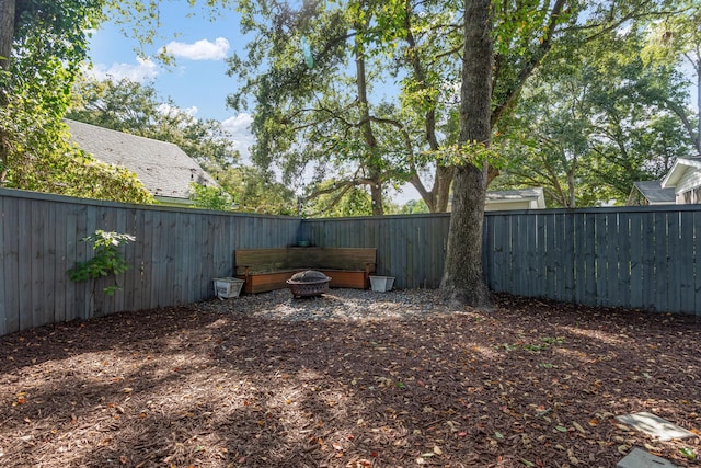 view of yard with an outdoor fire pit