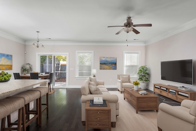 living room with crown molding, plenty of natural light, and light wood-type flooring