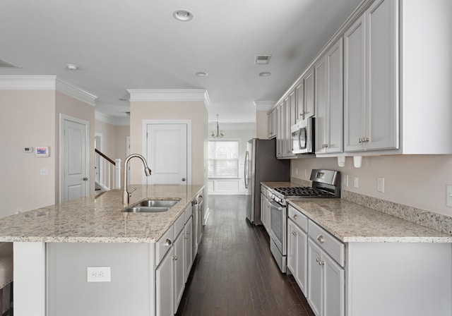 kitchen featuring sink, a kitchen island with sink, stainless steel appliances, light stone counters, and dark hardwood / wood-style flooring