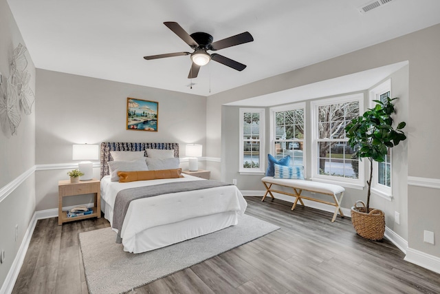 bedroom featuring hardwood / wood-style floors and ceiling fan