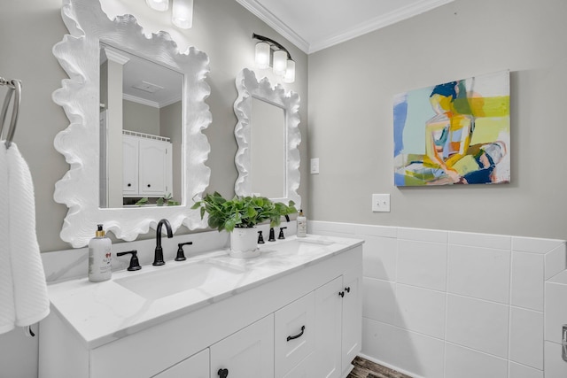 bathroom featuring ornamental molding, tile walls, and vanity