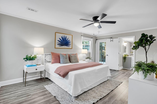 bedroom with ceiling fan, wood-type flooring, connected bathroom, and ornamental molding