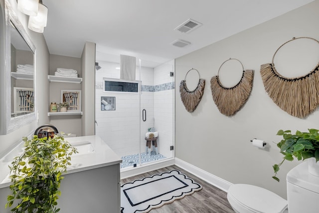 bathroom with vanity, hardwood / wood-style flooring, toilet, and walk in shower