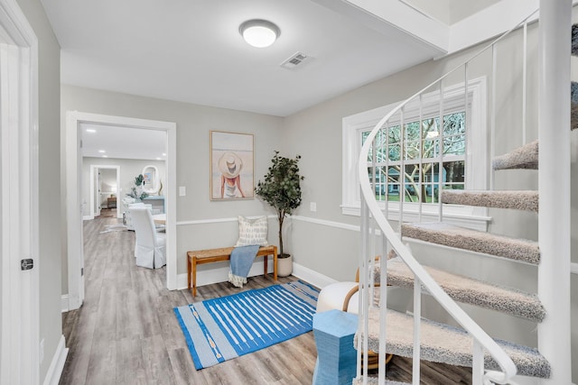 corridor with hardwood / wood-style flooring