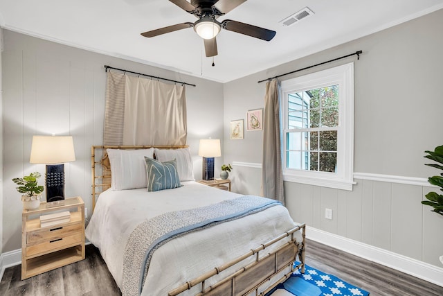 bedroom with dark hardwood / wood-style floors and ceiling fan