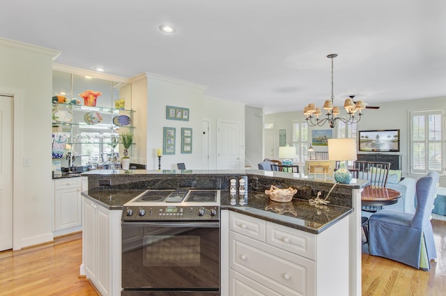 1647 Marsh Harbor Ln, Mount Pleasant, SC 29464 - kitchen with stainless steel electric range oven, a chandelier, light wood-type flooring, white cabinets, and ornamental molding