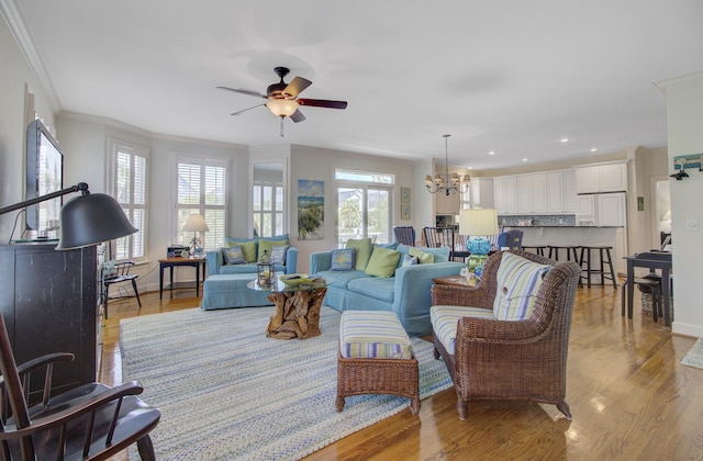 1647 Marsh Harbor Ln, Mount Pleasant, SC 29464 - living room featuring a chandelier, crown molding, a ceiling fan, light wood-type flooring, and recessed lighting