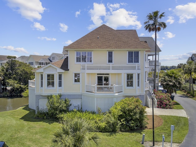 1647 Marsh Harbor Ln, Mount Pleasant, SC 29464 - back of house featuring a balcony, a yard, roof with shingles, and a water view