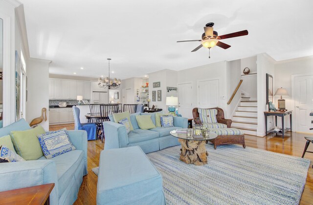 1647 Marsh Harbor Ln, Mount Pleasant, SC 29464 - living area featuring a chandelier, ceiling fan, stairs, light wood-type flooring, and recessed lighting