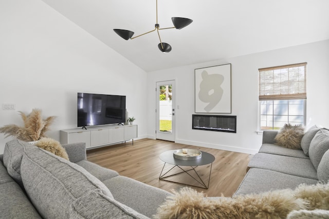1366 W Point Dr, Mount Pleasant, SC 29466 - living area featuring wood finished floors, high vaulted ceiling, baseboards, and a glass covered fireplace