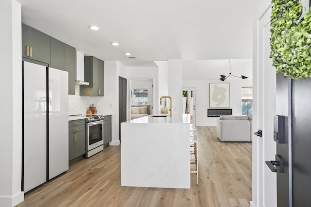 1366 W Point Dr, Mount Pleasant, SC 29466 - kitchen featuring electric stove, white fridge, a sink, light wood-style floors, and recessed lighting