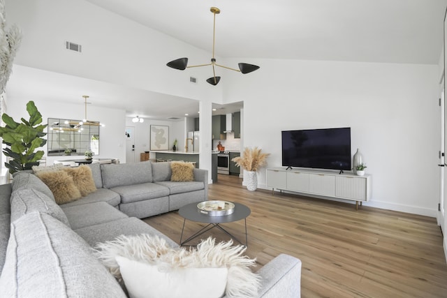 1366 W Point Dr, Mount Pleasant, SC 29466 - living room featuring wood finished floors, ceiling fan, baseboards, and high vaulted ceiling