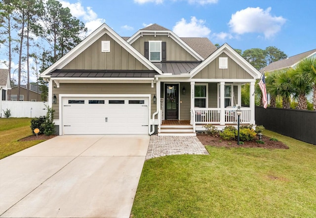 craftsman-style house with a garage, a front yard, and covered porch