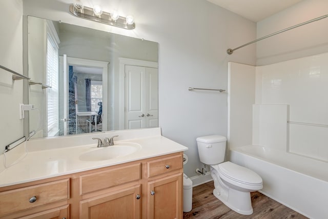 full bathroom with toilet, vanity, shower / bath combination, and hardwood / wood-style flooring