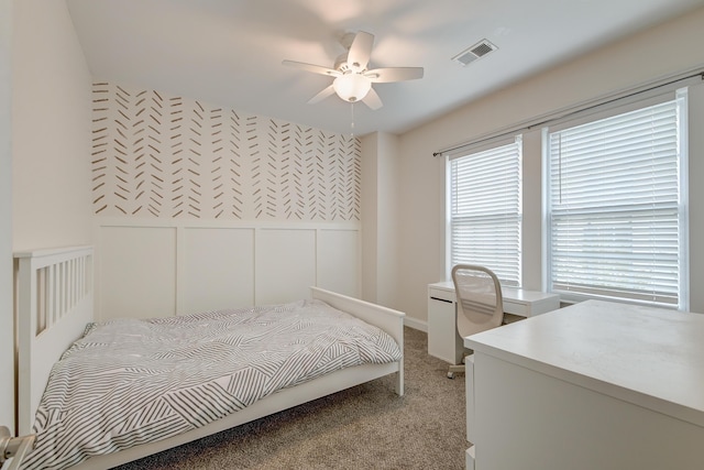 bedroom featuring ceiling fan and light carpet