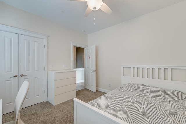 carpeted bedroom with ceiling fan and a closet