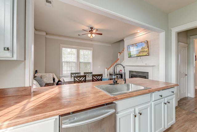 kitchen featuring dishwasher, white cabinets, sink, ceiling fan, and light hardwood / wood-style floors