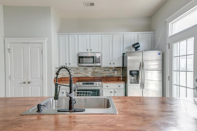 kitchen with white cabinetry, sink, and appliances with stainless steel finishes