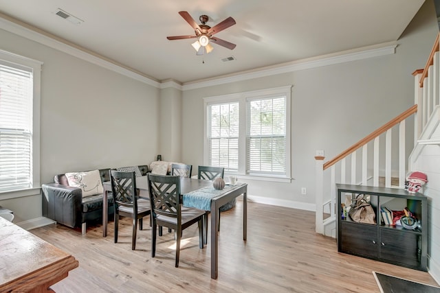 dining room with light wood-type flooring, ceiling fan, and ornamental molding