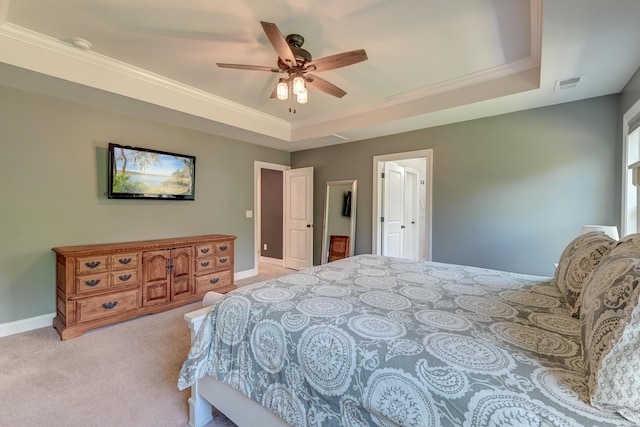bedroom with light colored carpet, a raised ceiling, crown molding, baseboards, and ceiling fan