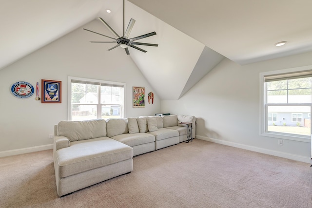 carpeted living room featuring a ceiling fan, lofted ceiling, plenty of natural light, and baseboards